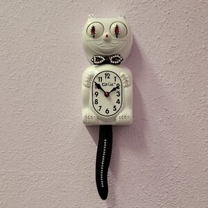 Jeweled White Kit-Cat Klock clock with black bow tie and tail